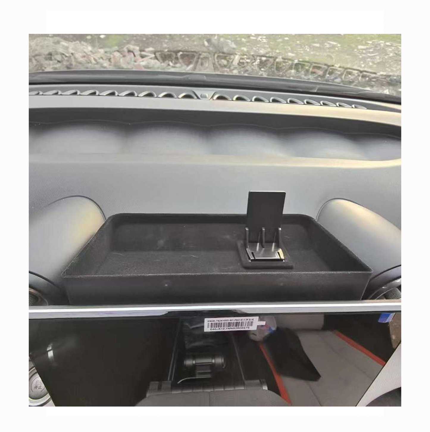 BYD dashboard storage tray with phone holder for organizing small items inside car.