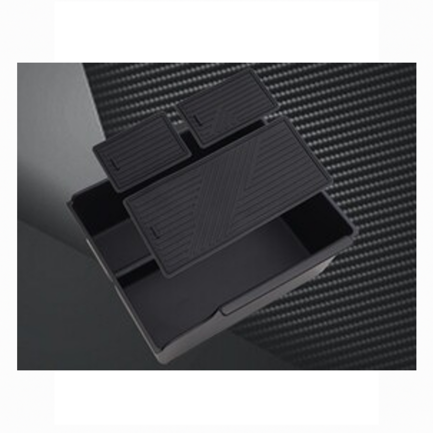 BYD ATTO 3 center console organizer box shown with three removable non-slip rubber mats floating above the compartments.