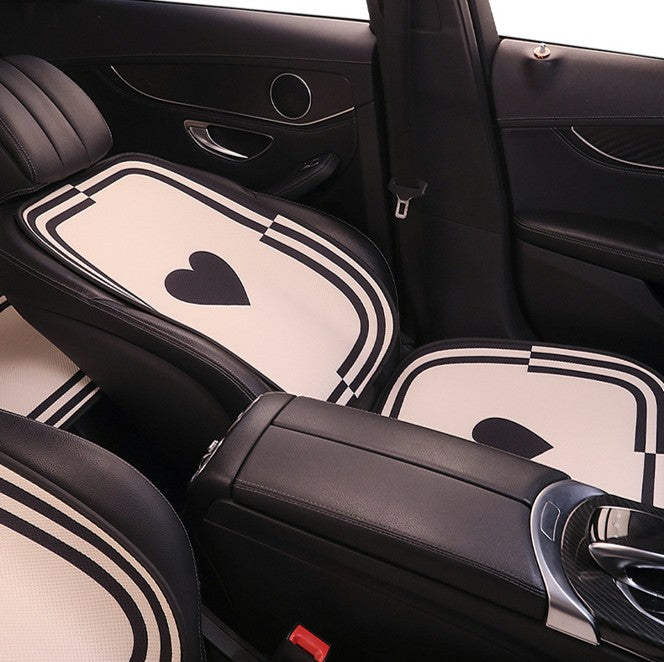 Rear seat view of BYD cartoon-style car seat cushions with heart pattern, showcasing elegant design and breathable fabric.
