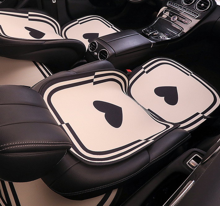 Close-up of BYD cartoon-style car seat cushions with heart pattern, breathable fabric, and elegant design.