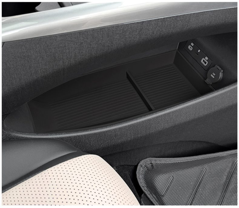 Empty BYD Dolphin center console organizer tray showing spacious storage compartment and clean interior design.