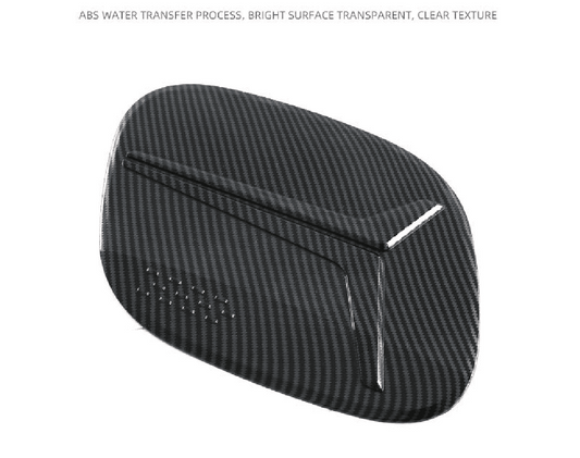 Close-up view of BYD Sealion 7 charging port cover in carbon fiber finish, made of durable ABS plastic with water transfer texture