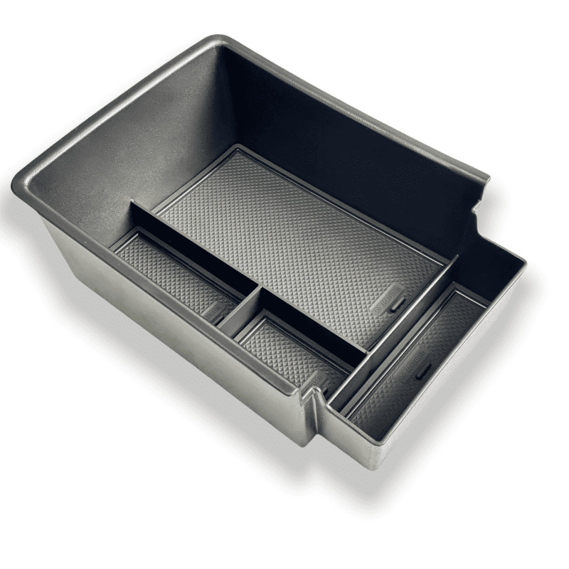 Side angle view of the BYD Sealion 7 lower center console organizer tray with textured anti-slip rubber mats, showing compartment layout and fitted inserts.