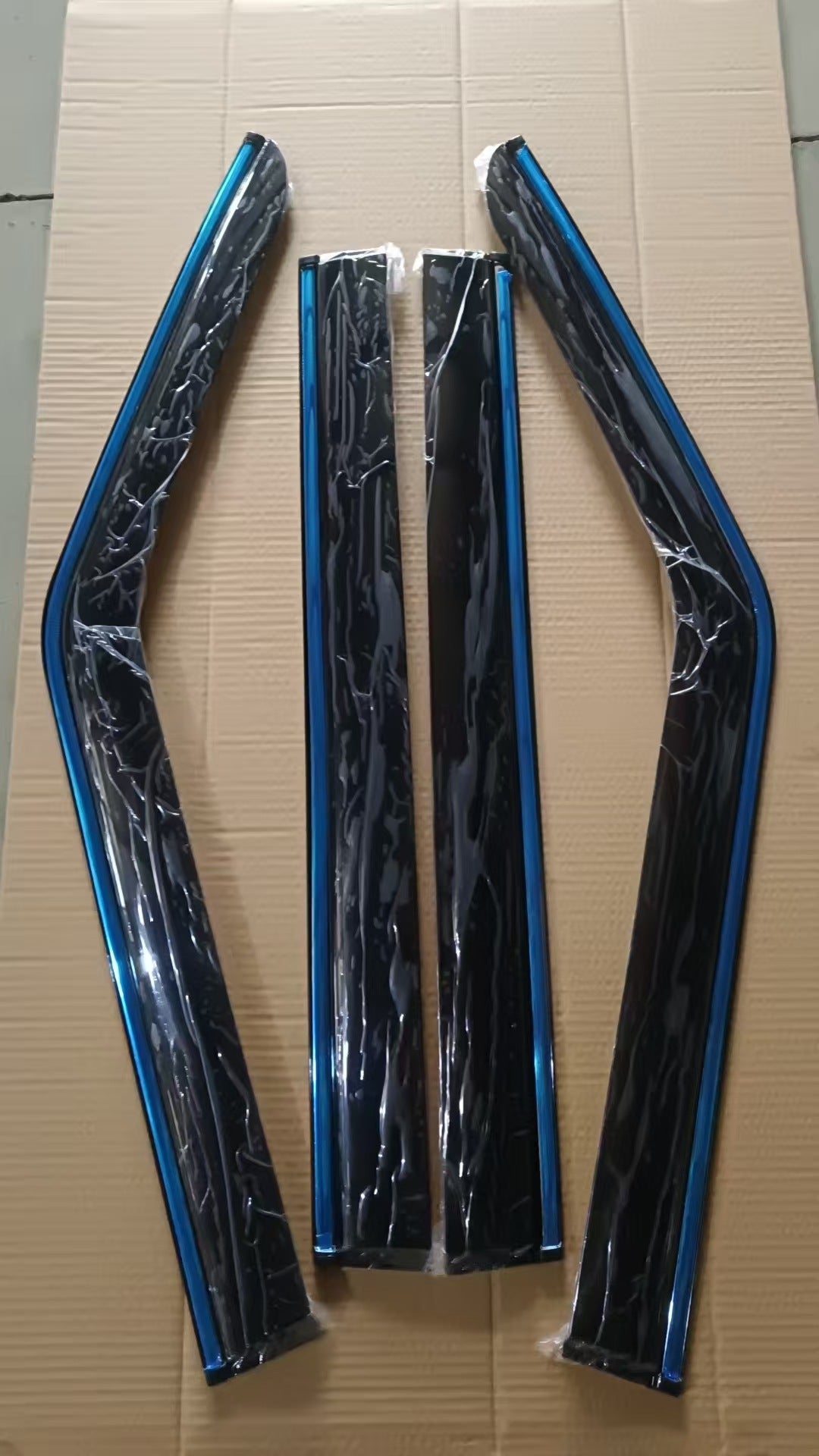 Real photo of 4-piece window visors for BYD Shark 6 with protective film, shown before installation