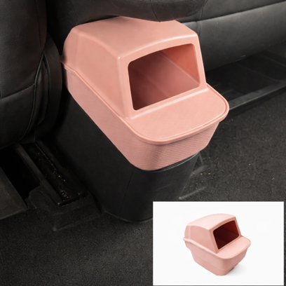 Pink BYDREAM rear seat trash bin installed behind the centre console in a BYD ATTO 1, custom-fit car rubbish bin with easy-access opening and inset product image.