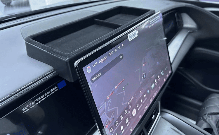 Installed view of dashboard storage tray mounted behind the center touchscreen in a BYD Sealion 7, showing precise fit and easy access.