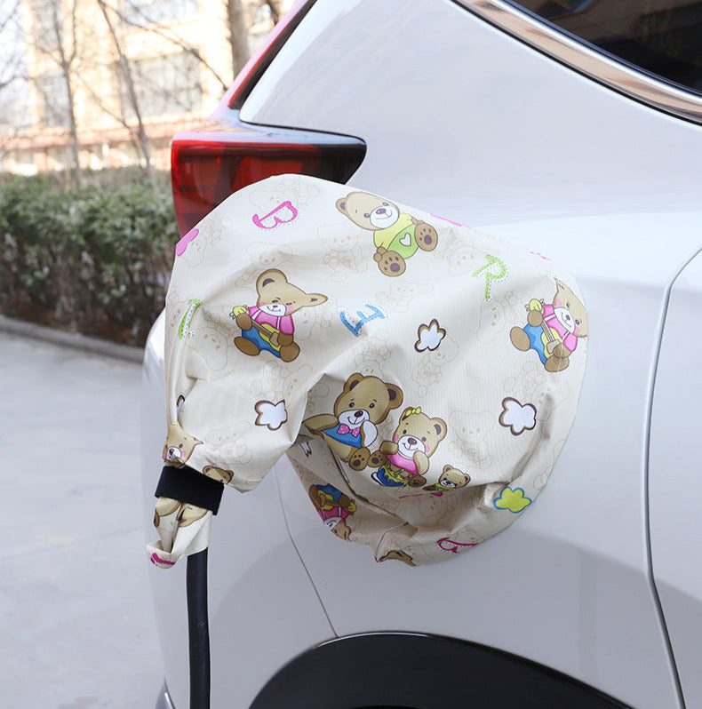 Beige EV charging port cover with cartoon bear design, protecting BYD vehicle’s charging area from rain, dust, and sunlight.