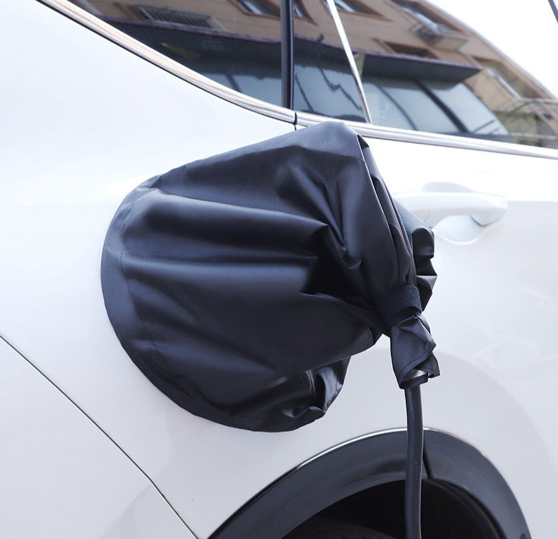 Black waterproof EV charging port cover fitted on a white BYD vehicle, offering dust and rain protection for outdoor charging scenarios.