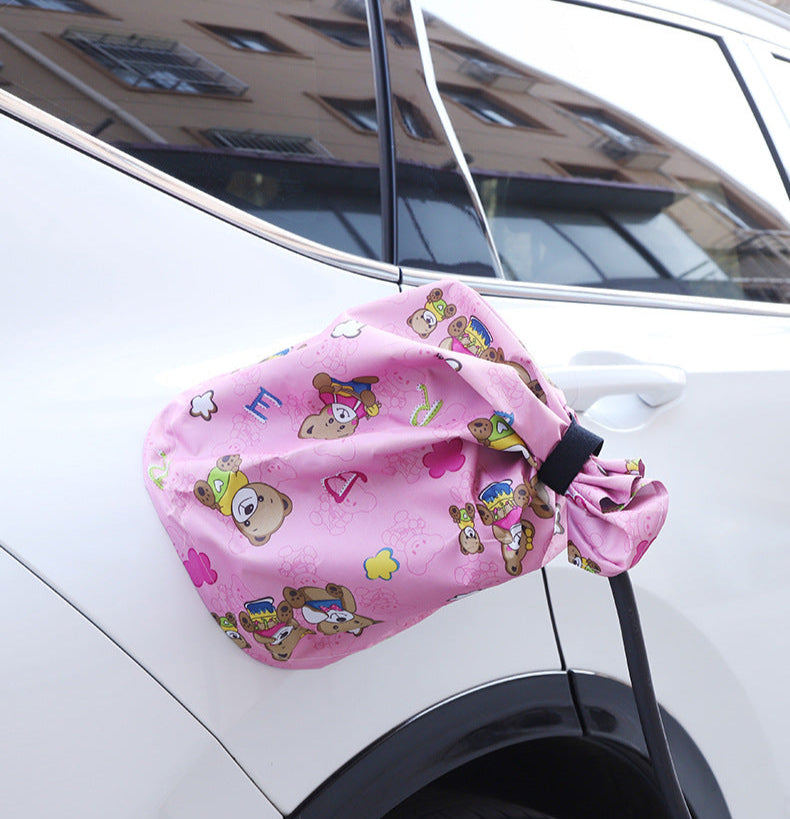 Pink cartoon-style EV charger port cover installed on a BYD vehicle, designed for water and dust protection with a fun and playful look.