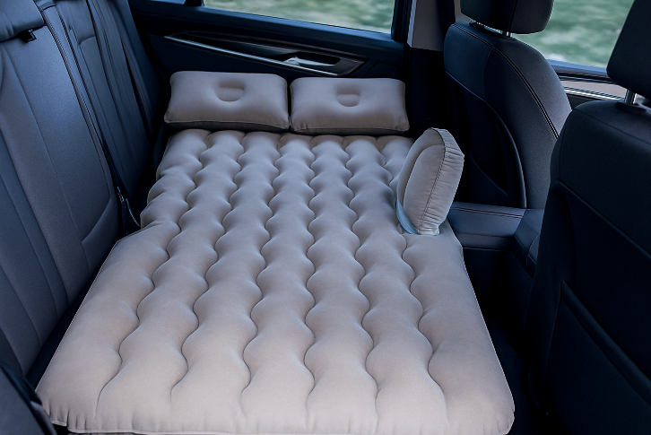 Light beige inflatable car mattress for BYD models, fitted in rear seat, ideal for camping, travel rest, and backseat sleeping comfort.