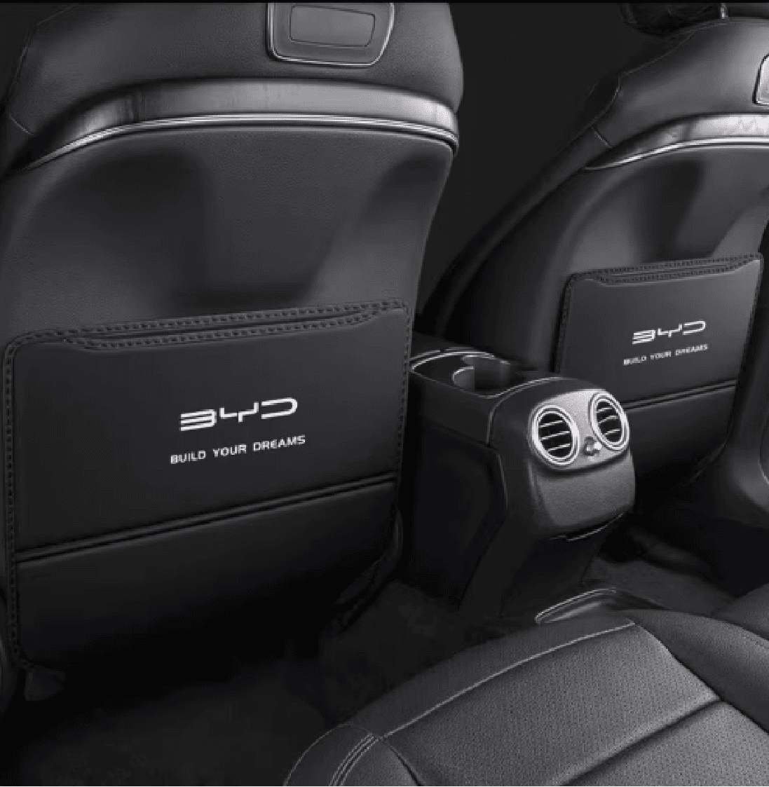 Rear seat view of installed kick pads in BYD Sealion 6 with BYD logo and center air vents visible