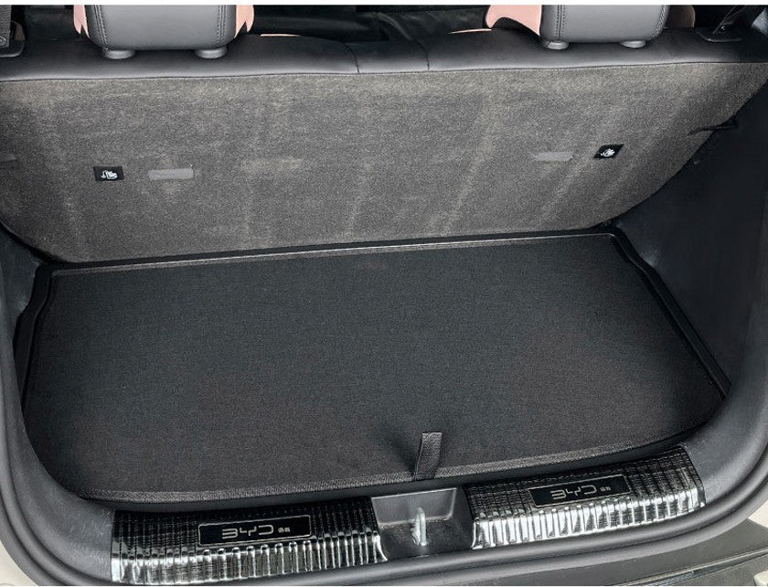 BYD ATTO 1 trunk boot lid panel installed (full-cover) with premium dual-layer felt finish and pull tab for easy access to underfloor storage; custom-fit panel helps reduce noise and keeps the boot tidy (BYDREAM).