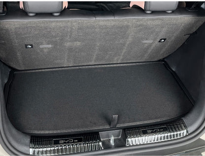 BYD ATTO 1 trunk boot lid panel installed (full-cover) with premium dual-layer felt finish and pull tab for easy access to underfloor storage; custom-fit panel helps reduce noise and keeps the boot tidy (BYDREAM).