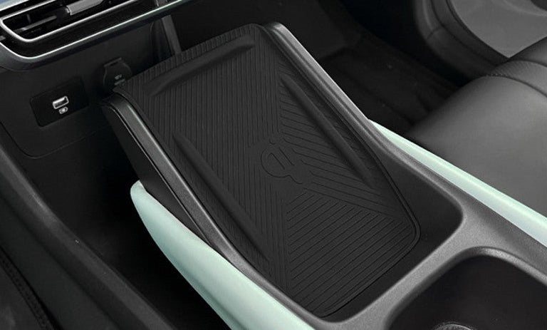 Wide view of BYD ATTO 1 centre console wireless charging area with non-slip silicone mat fitted, protecting the charging pad and keeping the console tidy (Australia)