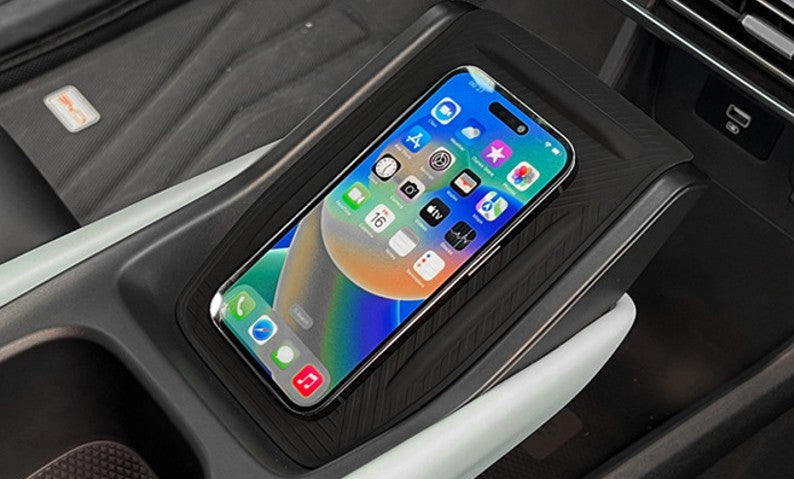 Phone sitting securely on BYD ATTO 1 centre console wireless charging pad with non-slip silicone mat installed, helps prevent sliding while driving (Australia)