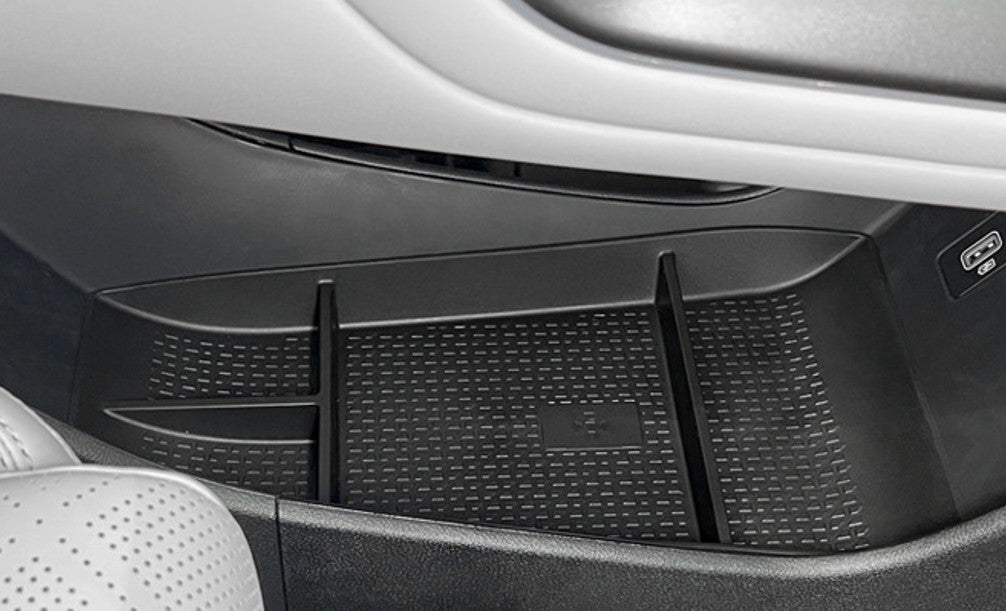 Installed BYD ATTO 2 (2025+) centre console lower storage organiser tray insert, showing divided compartments and anti-slip textured TPE surface for keeping small items neatly organised.