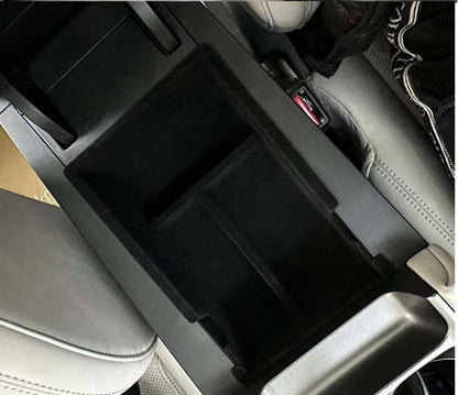 BYD ATTO 2 (2025+) centre console organiser insert installed inside the armrest storage compartment, showing a custom-fit black tray that helps sort keys, coins and small items (BYDream).