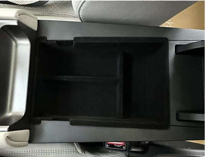 Top view of the BYD ATTO 2 (2025+) centre console organiser tray insert in black, showing a custom-fit armrest storage divider to keep phone, keys and small items neatly separated (BYDream).