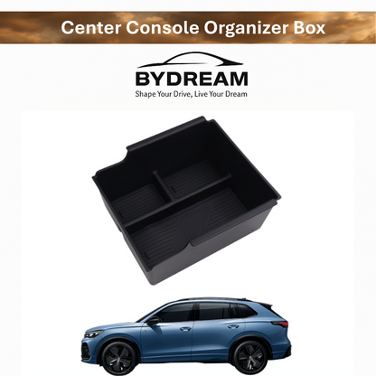 Center console organizer box for BYD ATTO 3, black plastic tray with divided compartments, shown above a blue BYD SUV.

