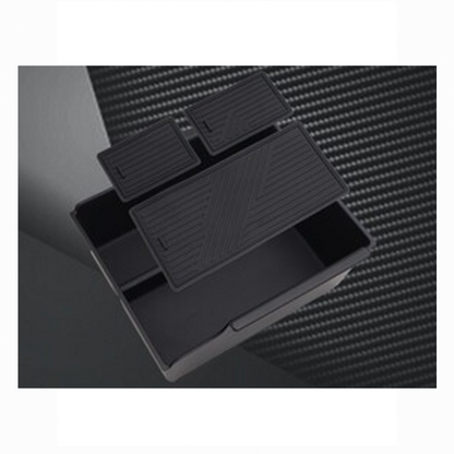 BYD ATTO 3 center console organizer box shown with three removable non-slip rubber mats floating above the compartments.