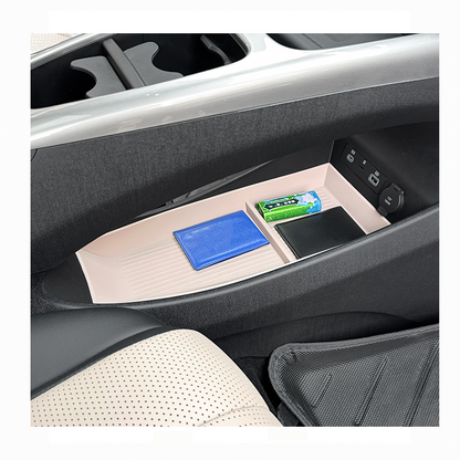 BYD Dolphin center console organizer tray holding wallet, tissues, and small items, showing organized car interior storage space.