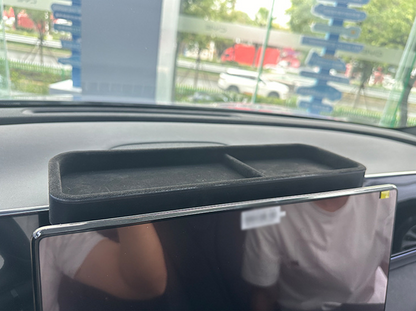 Installed view of BYD Seal dashboard rear organizer tray in black ABS, perfectly fitting behind touchscreen, providing hidden storage for keys, glasses, and small items