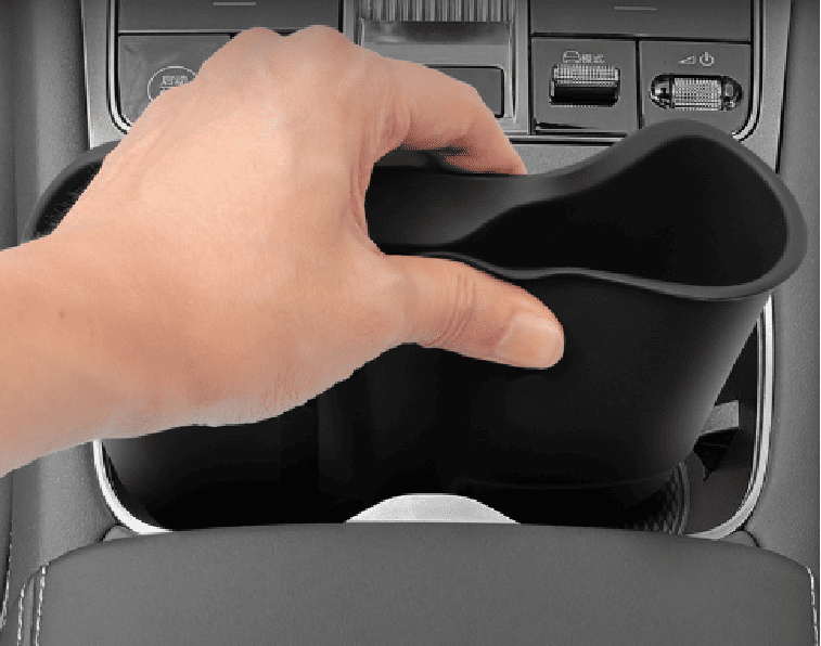 Hand placing anti-slip cup holder insert into BYD Sealion 7 center console, demonstrating easy tool-free installation.