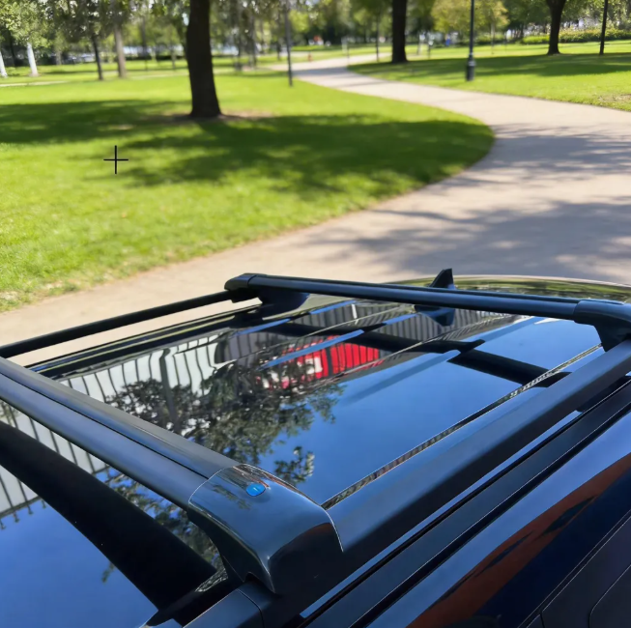 Close up of roof rack cross bars mounted on BYD Shark 6 roof rails