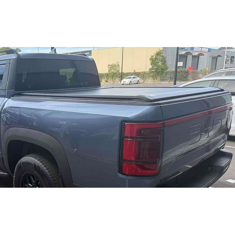 BYDREAM aluminum retractable tonneau cover for BYD Shark 6, outdoor rear view installed on blue-gray pickup