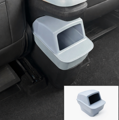 Light blue BYDREAM rear seat trash bin installed behind the centre console in a BYD ATTO 1, showing a custom-fit car rubbish bin with an inset product image.