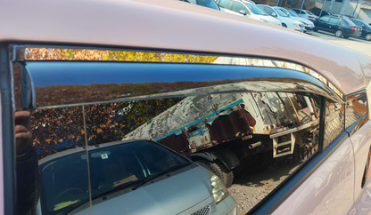 Close-up of BYD ATTO 1 window visor installed — dark tinted rain guard / wind deflector showing tight fit along the side window frame