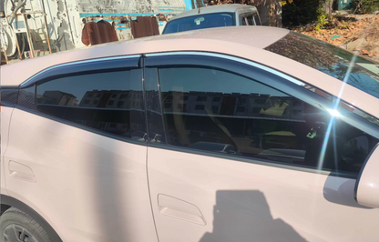 BYD ATTO 1 window visors installed — side view showing dark tinted rain guards / wind deflectors on the windows for a clean OEM-style fit