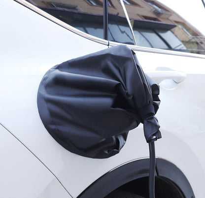 Black waterproof EV charging port cover fitted on a white BYD vehicle, offering dust and rain protection for outdoor charging scenarios.
